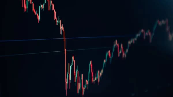 candlestick stock chart on dark screen