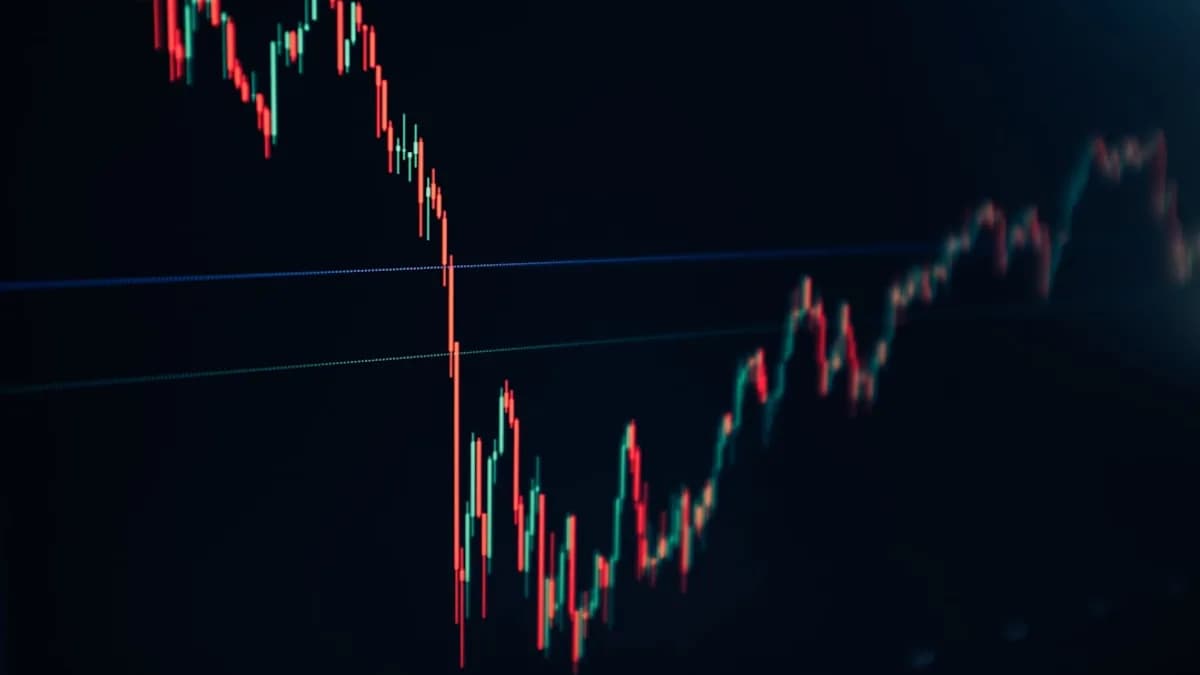 candlestick stock chart on dark screen