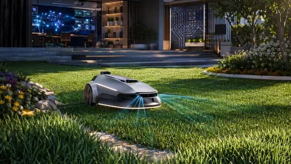 Autonomous robot mower navigating a lush lawn beside a futuristic smart home workspace.