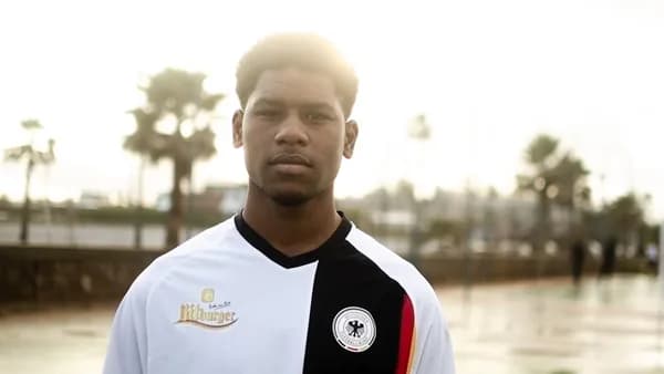 Young man in a black and white soccer jersey.