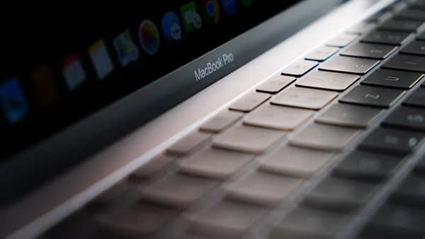 Detailed close-up of a MacBook Pro keyboard showing the keys and backlight.