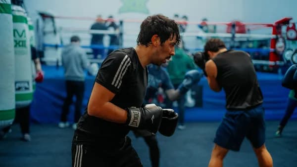 Boxers engaged in a rigorous training session inside a Buenos Aires gym.