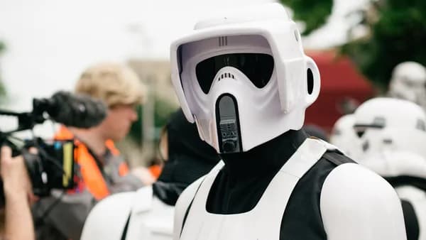 Close-up of a person dressed as a stormtrooper participating in an outdoor cosplay event.