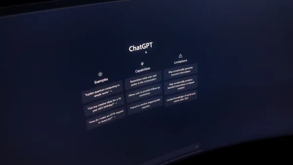 Close-up of a computer screen displaying ChatGPT interface in a dark setting.