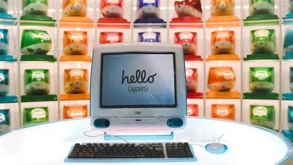 Retro Apple iMac G3 display showcasing technology evolution with colorful computer units.