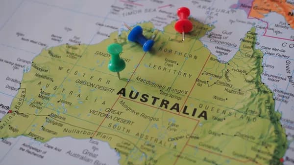 Close-up of a map of Australia featuring colorful pushpins marking locations.