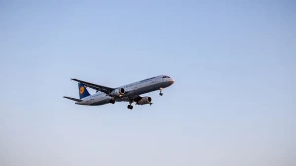 Passenger airplane in flight against blue sky, showcasing air travel and aviation technology.
