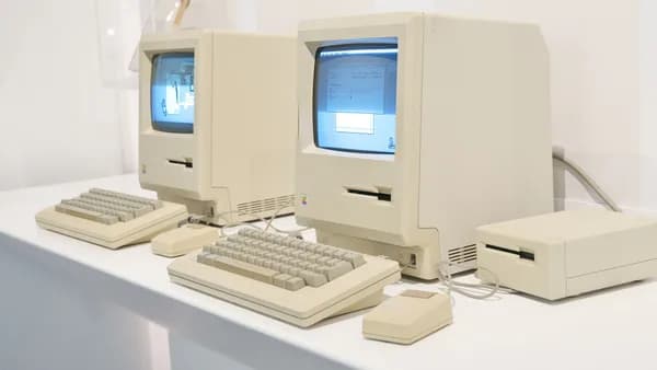 Close-up of retro Apple Macintosh computers showcasing early personal computing history.