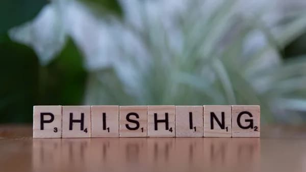 Wooden tiles spelling 'phishing' highlight cybersecurity themes.