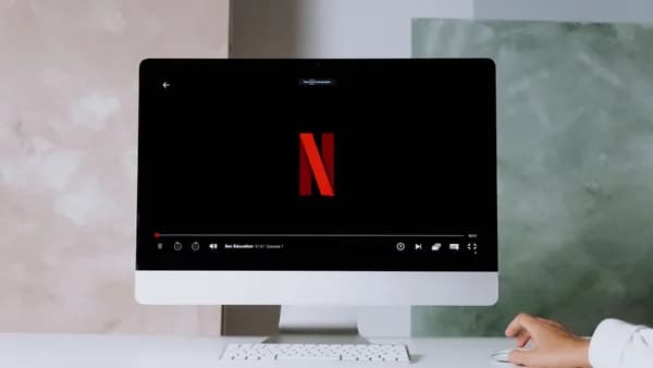 A minimalist workspace scene featuring a desktop displaying a streaming service, ideal for modern lifestyle themes.