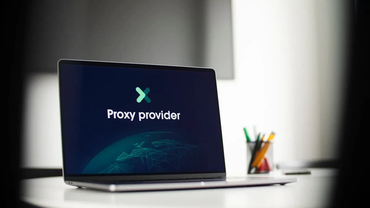 Laptop screen showing 'Proxy provider' in a tech office setting, focus on cybersecurity.