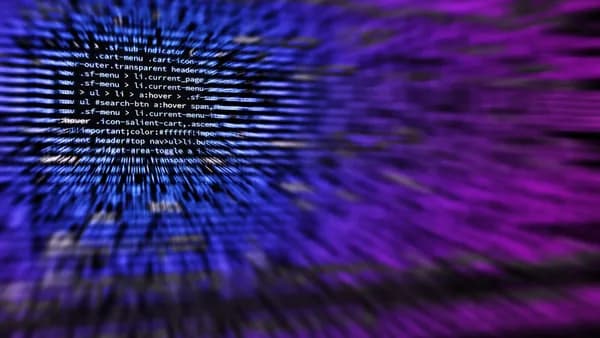 Dynamic abstract background featuring computer code in focus with blurred effect.
