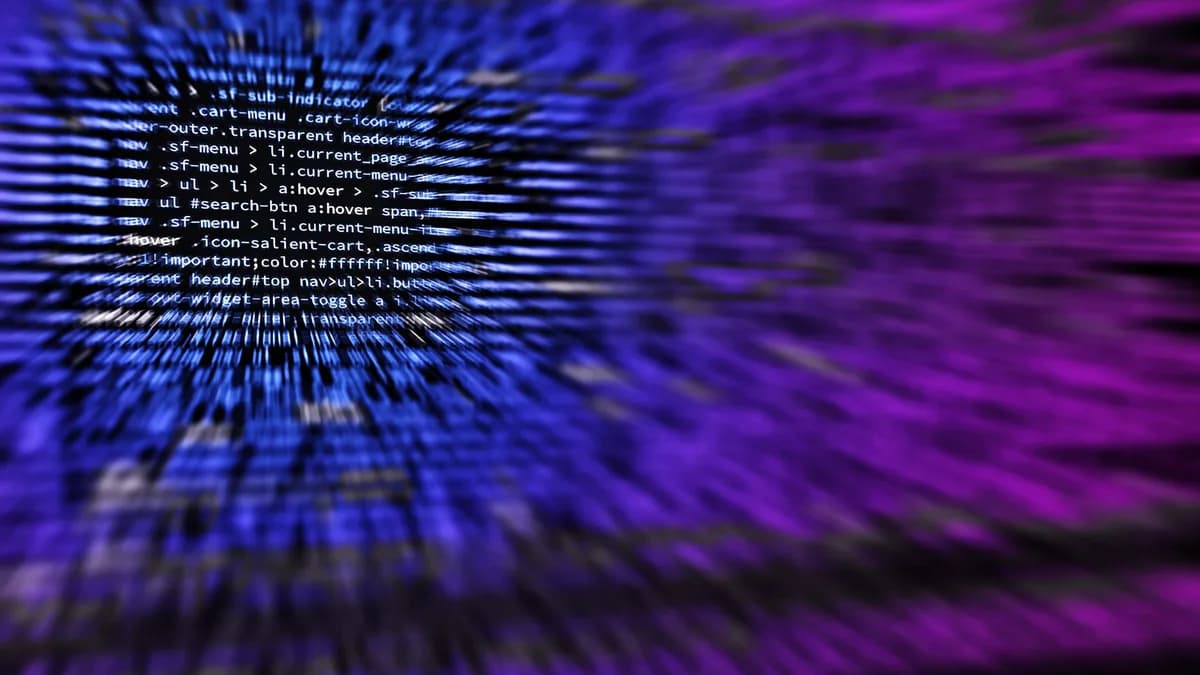 Dynamic abstract background featuring computer code in focus with blurred effect.
