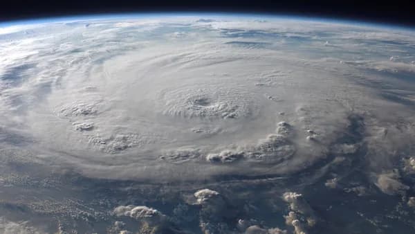 A stunning aerial view of Earth with a massive swirling hurricane, highlighting meteorological beauty.