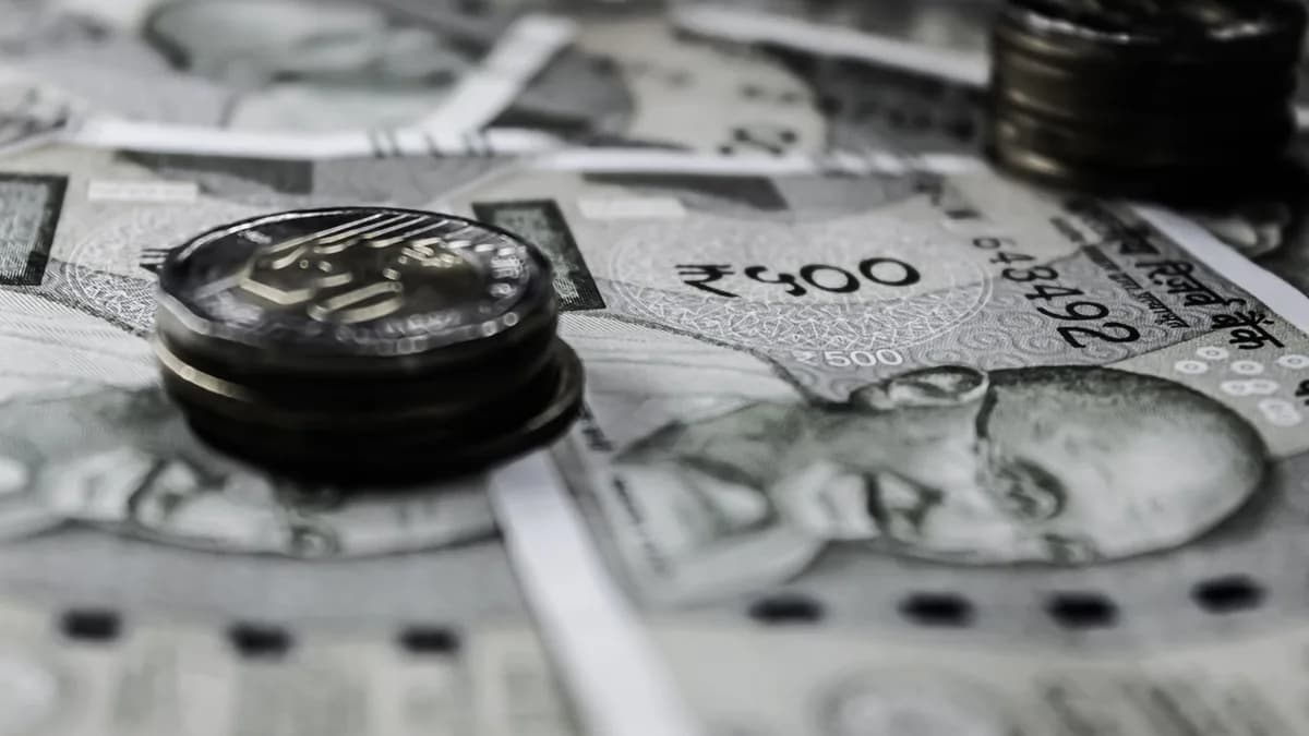 A detailed close-up of Indian currency notes and coins, highlighting financial themes.