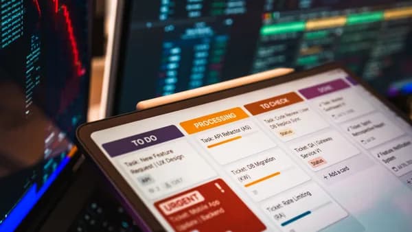 Kanban board displayed on screen with charts and data analysis in modern office setup.