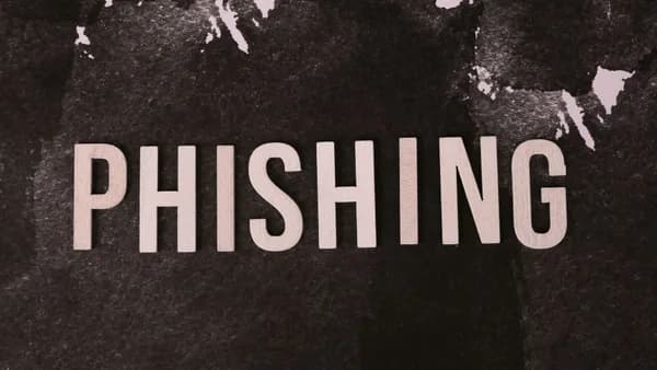 Abstract representation of phishing with the text on a textured dark surface.