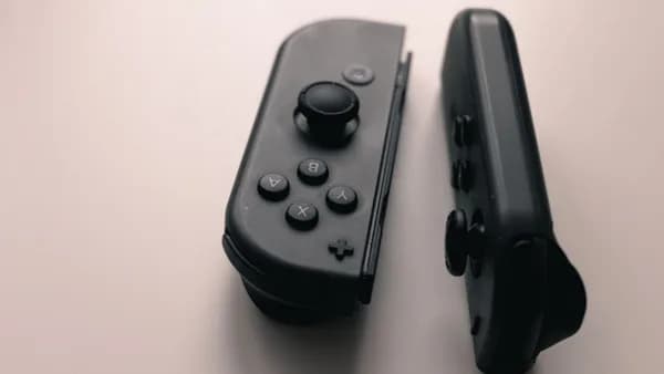 A close-up image of two Nintendo Switch Joy-Con controllers on a neutral background.