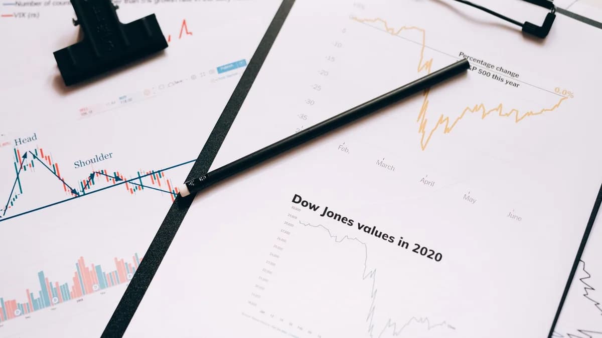 Clipboard with stock market charts and graphs representing financial data analysis.
