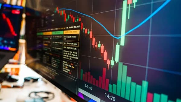 Close-up of a financial monitor displaying real-time cryptocurrency data and charts in a modern office.