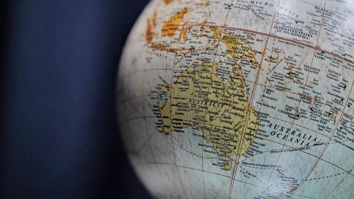 A detailed close-up of a vintage globe focusing on Australia and Oceania, highlighting geographical textures.
