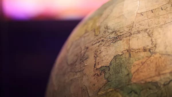 Close-up of a vintage globe with a focus on the North Atlantic Ocean.