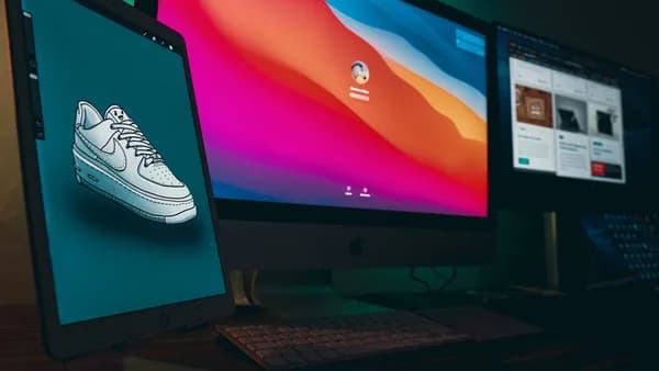 A digital workspace featuring Apple devices with Nike sneaker design displayed on a tablet.