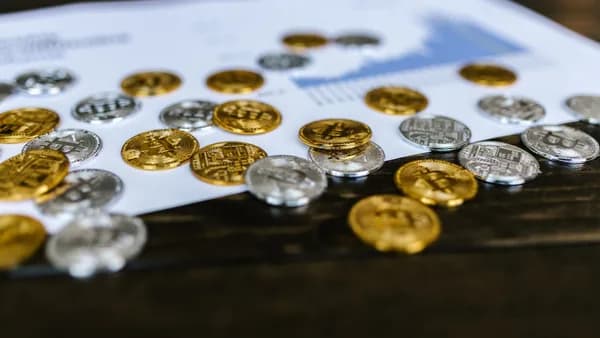 Digital currency coins on a paper chart, showcasing financial growth insights.