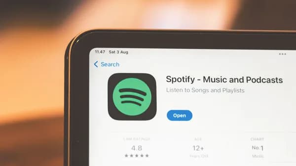 Close-up of Spotify app page displayed on a tablet screen, highlighting its features.