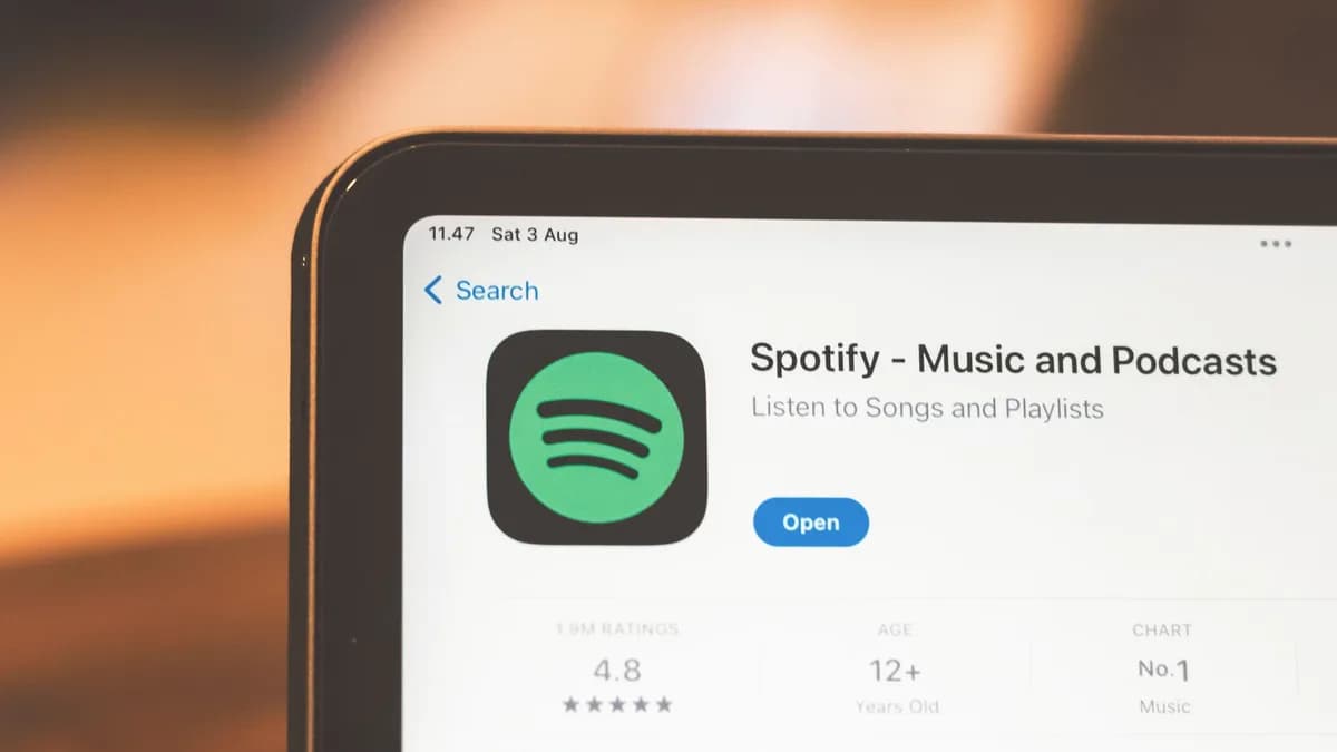 Close-up of Spotify app page displayed on a tablet screen, highlighting its features.