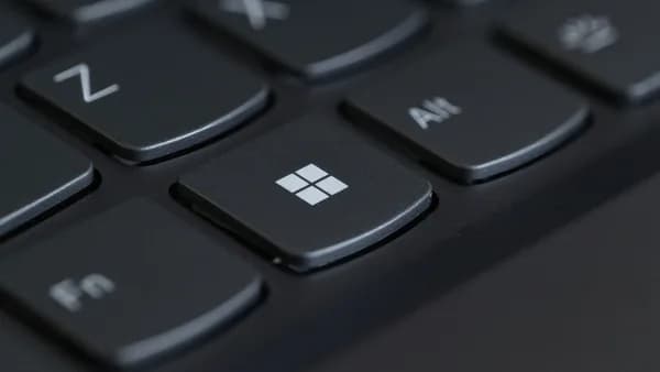 Detailed close-up of a computer keyboard featuring the Windows key in focus.