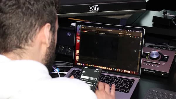 a man sitting in front of a laptop computer