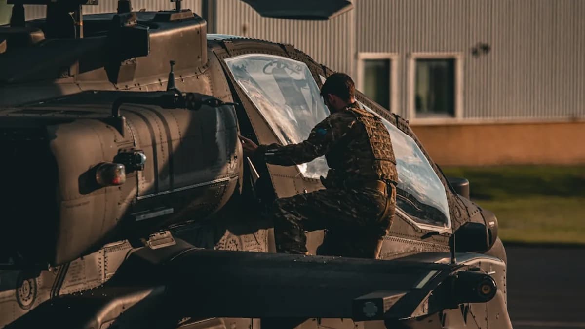 A man standing in front of a helicopter