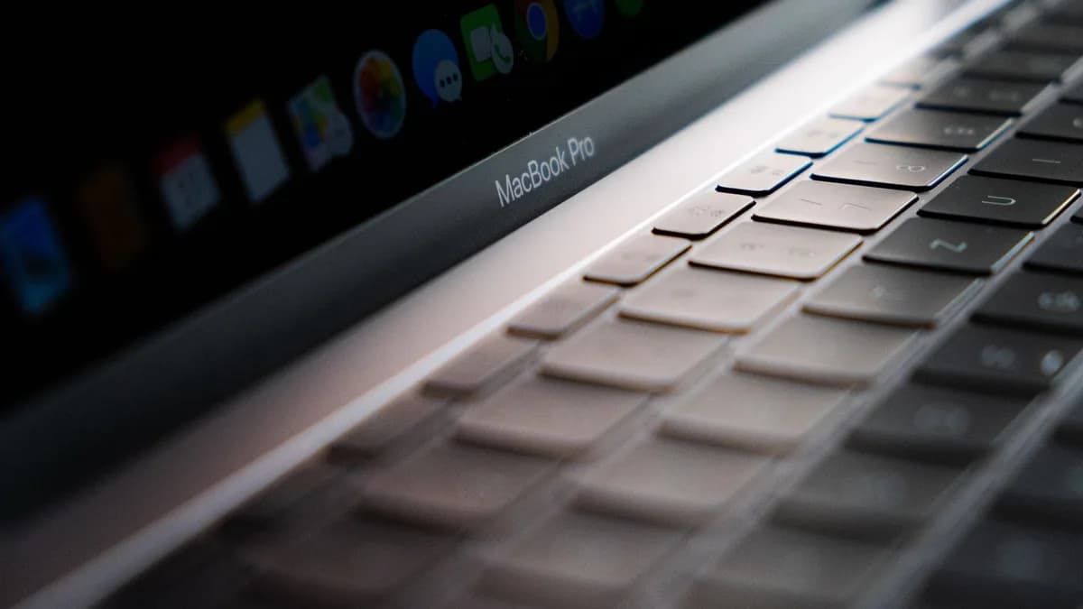Detailed close-up of a MacBook Pro keyboard showing the keys and backlight.