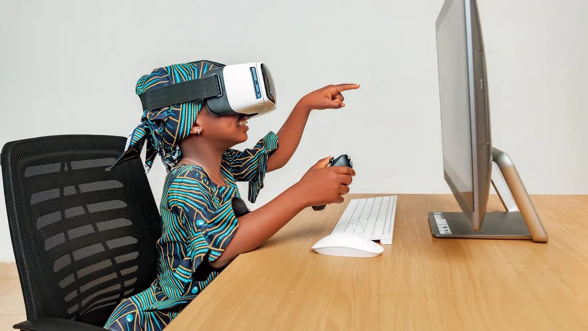 Young child using a VR headset and controller at a desk, engaging with technology.