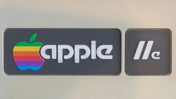 Close-up of retro Apple IIe computer logo featuring rainbow apple symbol, showcasing vintage technology design.