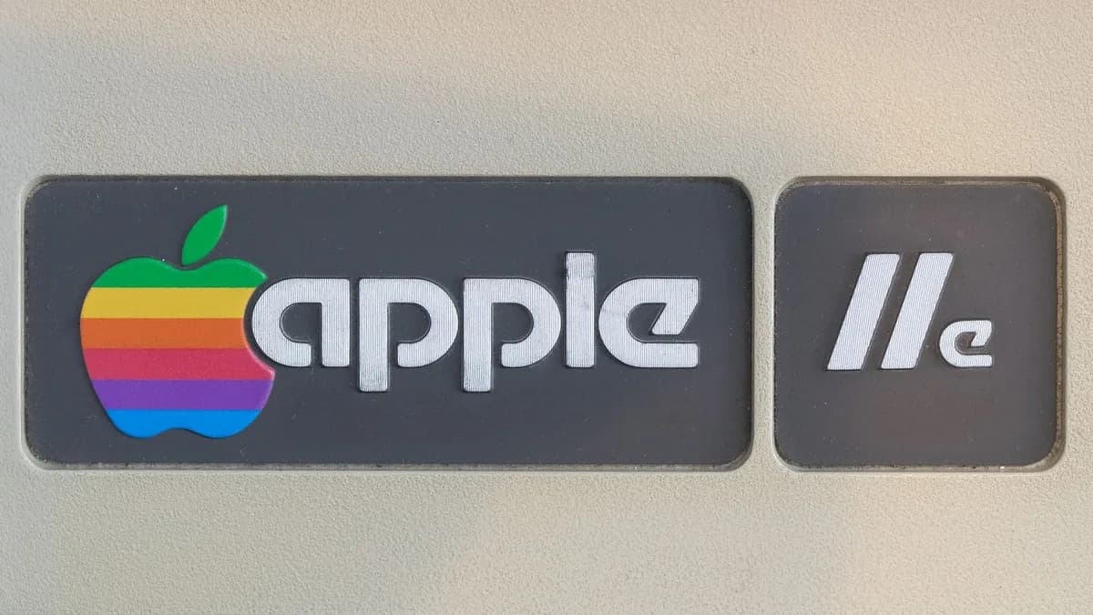 Close-up of retro Apple IIe computer logo featuring rainbow apple symbol, showcasing vintage technology design.