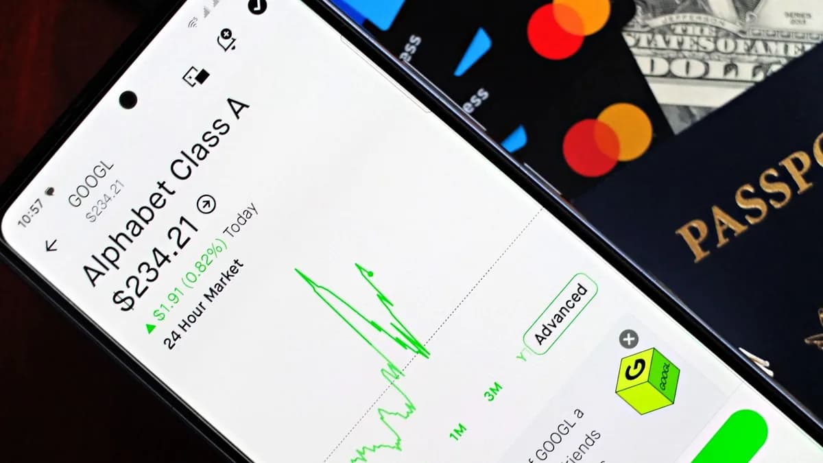 Smartphone displaying stock market app next to U.S. dollar and passport, representing global finance.