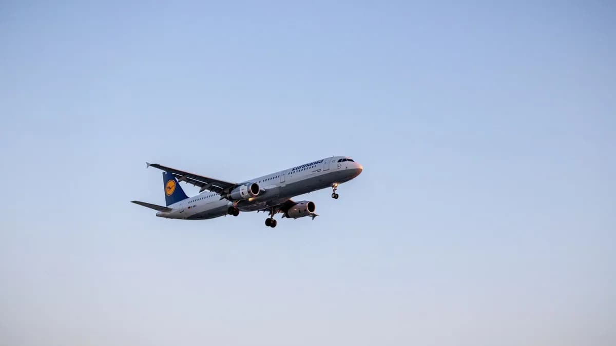 Passenger airplane in flight against blue sky, showcasing air travel and aviation technology.