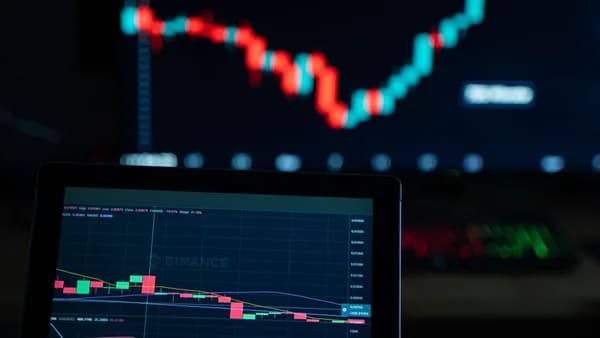 Detailed view of cryptocurrency trading charts on digital screens, showcasing market fluctuations.