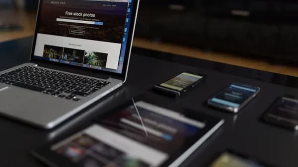 A contemporary workspace showcasing a laptop, tablet, and smartphones, ideal for tech and freelance use.