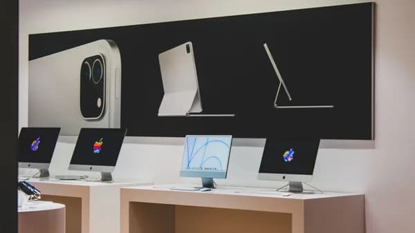 A sleek computer store featuring modern desktop displays and technology advertisements.