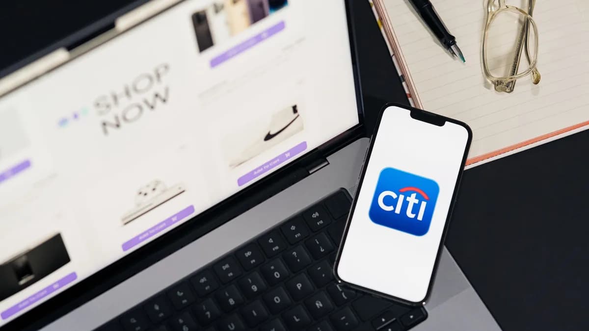 Laptop and smartphone showcasing online shopping and Citi mobile banking app