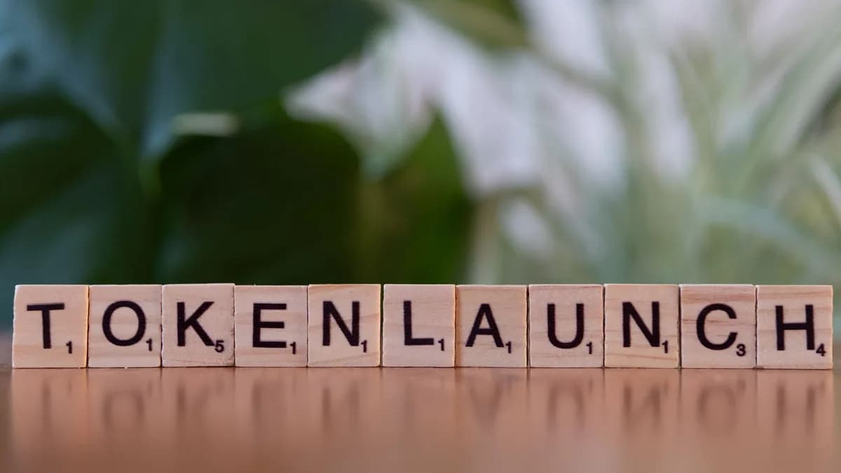 Scrabble tiles spelling 'Token Launch' on a vibrant green background.
