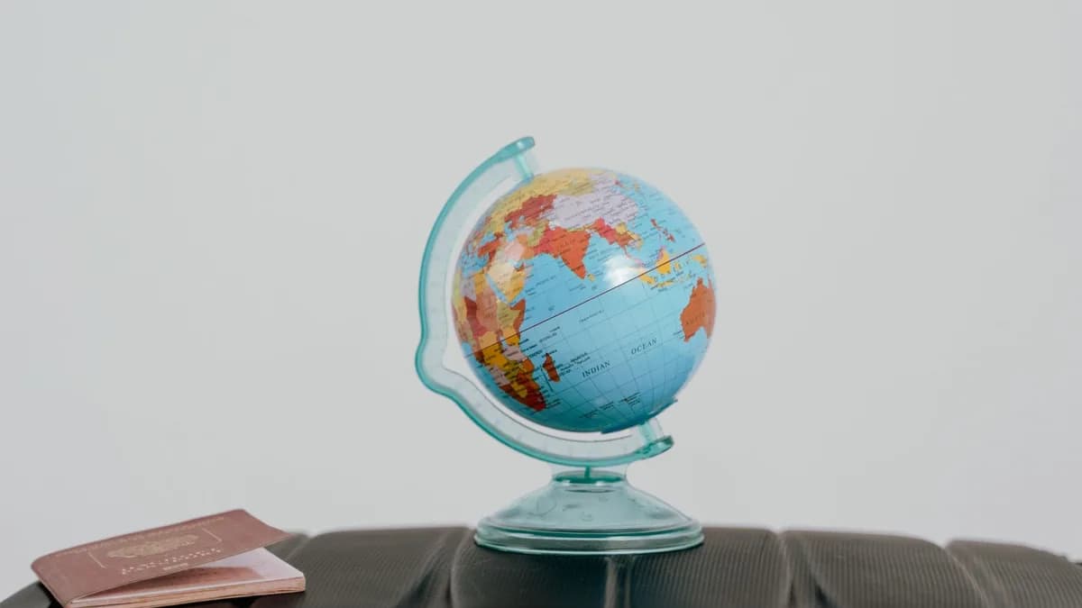 A globe and passport on a suitcase, symbolizing travel planning and wanderlust.
