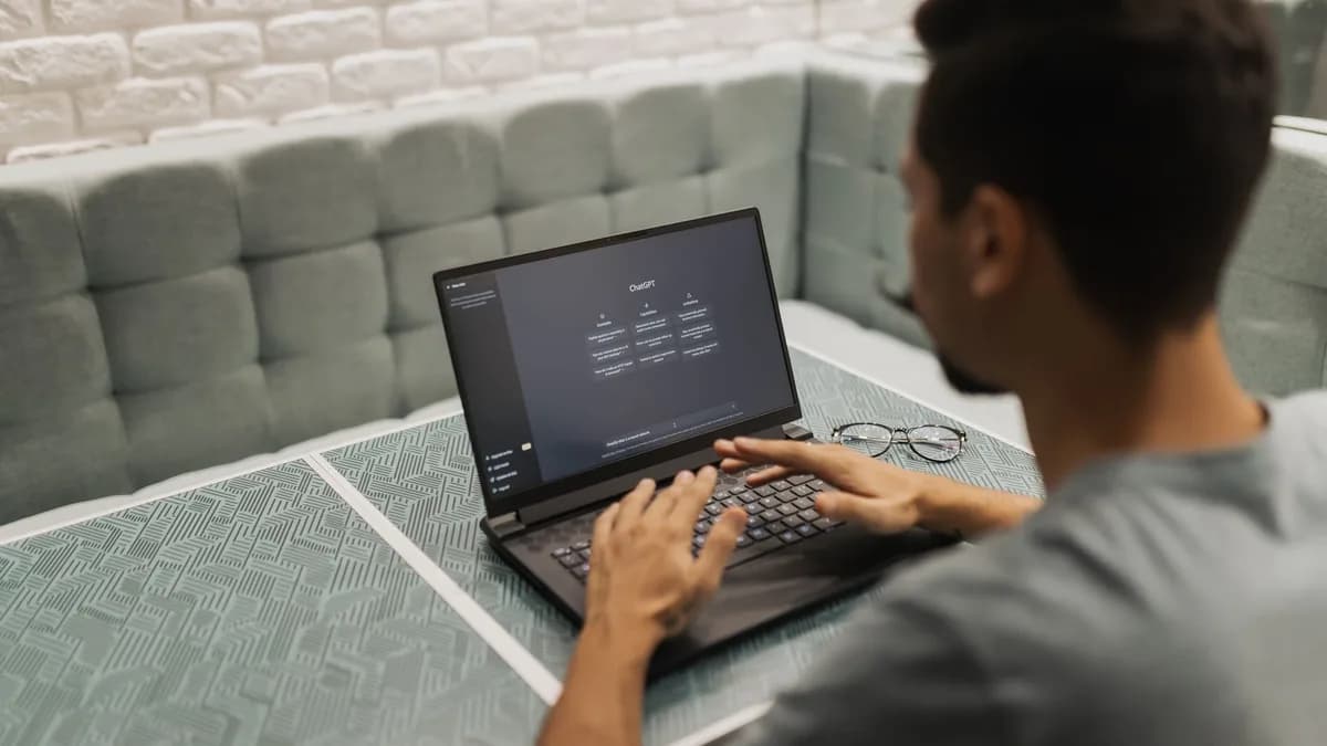 A man working on a laptop in a cozy, modern office space with a focus on technology.