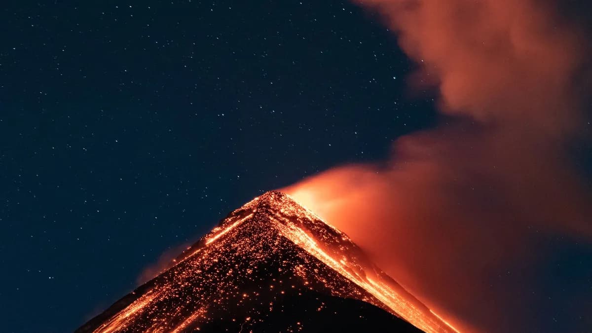 Stunning volcanic eruption in Guatemala captured at night with glowing lava and smoke.