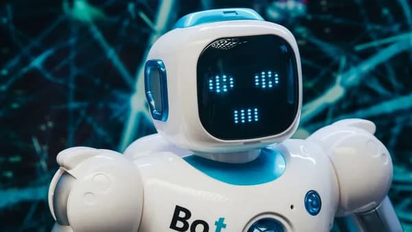 Close-up of a futuristic humanoid robot with a digital face display, representing modern technology.