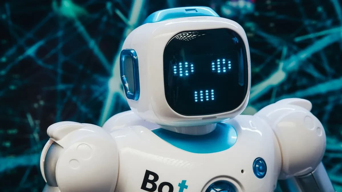 Close-up of a futuristic humanoid robot with a digital face display, representing modern technology.