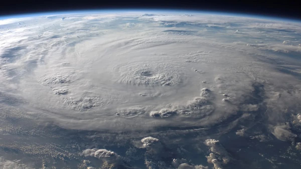 A stunning aerial view of Earth with a massive swirling hurricane, highlighting meteorological beauty.